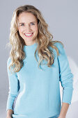 Blond woman wearing a light blue sweater