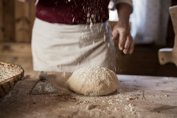 Dusting a ball of dough with flour