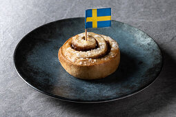 Cinnamon roll buns Kanelbulle traditional Swedish dessert served in black plate