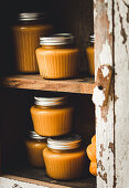 Pumpkin puree in preserving jars on a shelf