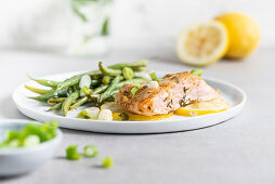 Marinated salmon with green beans, spring onions and lemons