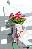 Small bouquet of bellis and decorative rooster