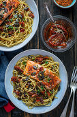 Spaghetti with pesto, dried tomatoes and baked salmon