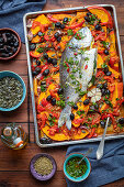 Dorada baked with pumpkin, pepper and tomatoes