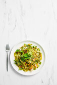 Barramundi pasta with green tomato, parsley oil and finger lime