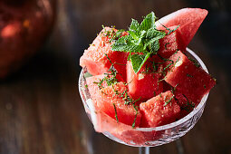 Watermelon salad with mint served in a stemmed glass