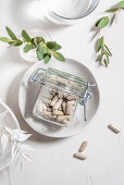 A jar on supplements in a dish