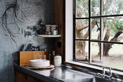 Kitchenette with sheet metal worktop and sink in rustic ambience