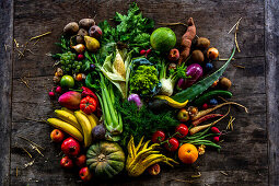 Local and exotic fruits and vegetables on a rustic wooden table