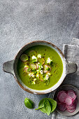 Zucchini and apple soup with feta, finely chopped radish, basil and olive oil