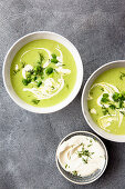 Broad bean soup garnished with dill and crème fraiche