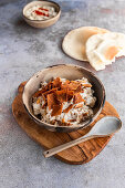 Chickpea Fatte or Fatteh is a popular Lebanese dish of crunchy pita bread topped with warm chickpeas and yogurt