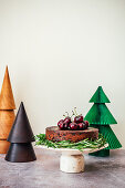 Fruit Cake in setting with Paper and Wooden Christmas Trees