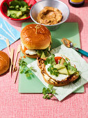 Grilled satay chicken burger with fried egg and pickled cucumber