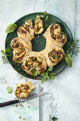 Stuffed herb and cheese curls with dried tomatoes and taleggio