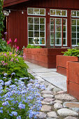 Paving stones and stepping stones between flower beds and raised beds