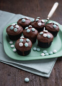 Vegan chocolate mint muffins with dark chocolate icing and mint dragees
