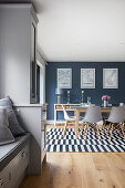 View of dining area with black and white striped carpet against a blue wall