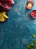 Blue background with a lantern, pomegranate and lemon wedges
