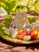 A cheese platter with apricots