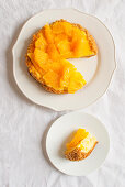 Cream cheese cake with oranges and pine nuts