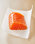 A piece of fresh salmon on paper