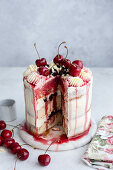 Cherry-cream cake with white chocolate, sliced