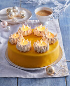 Christmas cake decorated with meringue bowls and tea lights