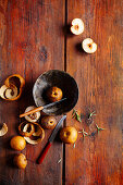 Nashi pears, partly peeled on wooden background