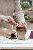 Self-made cake stands with feather wreaths; wooden discs; clay pots; eggs and radish in a pot