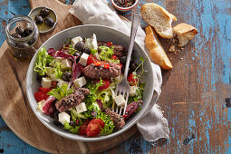 Salad with spicy minced sausage and feta