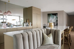 Kitchen island with custom made sofa in open-plan living room