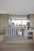 Kitchen island with custom-made sofa in open-plan living room