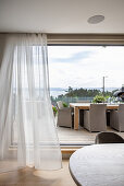 View from the dining area overlooking the terrace and the fjord