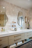 Elegant bathroom with long vanity and two organically shaped wall mirrors