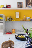 Light-colored kitchen with yellow stripe on the wall