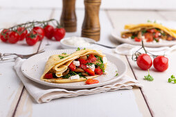 Spelt crêpes with rocket, peppers, mushrooms, tomatoes, and vegan cheese