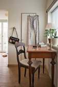 Antique desk and chair in front of the window