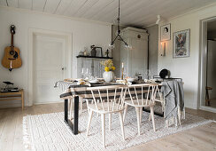 Cozy dining room with set table and guitar on the wall