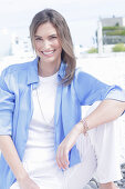 Young woman in white t-shirt, blue long blouse and white trousers