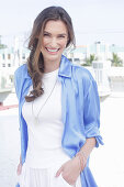 Young woman in white t-shirt, blue long blouse and white trousers