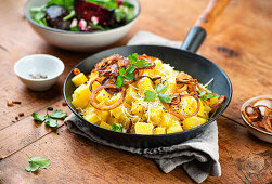 Fried cubed potatoes with cheese and roasted onions served with beet salad