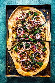 Rye tarte flambée with caponata and red onions