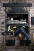 Man building a wood-fired oven