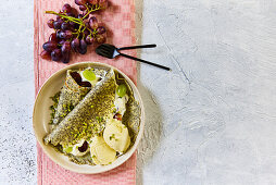 Poppy seed crepes with grapes and ice cream