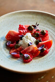 Tomato salad with burrata, raspberry and capers