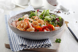 Shrimp and salmon over rice with salad