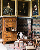 Framed artwork with table, chairs and writing bureau