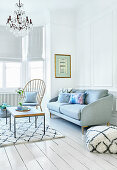 A white living room with grey sofa and coffee table