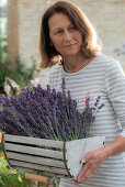 Frau mit frisch geerntetem Lavendel